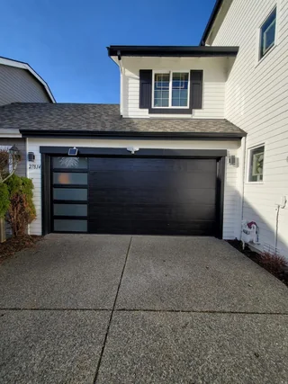 Modern black double garage door with side windows