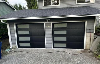 Matching black single garage doors with frosted windows