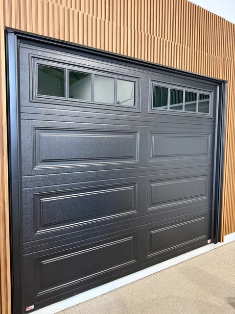 Modern black garage door with window panels