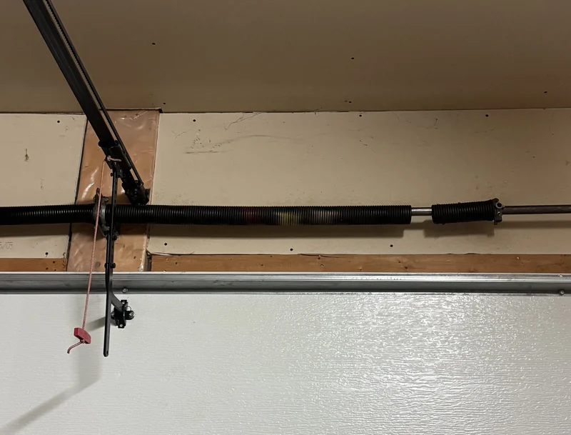 Broken torsion spring before garage door spring replacement